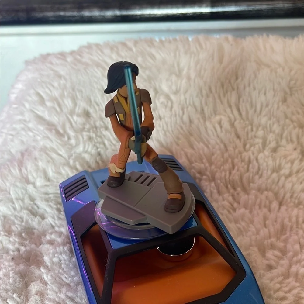 Action Figure with Blue Lightsaber on Vehicle